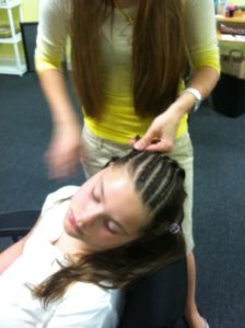 hair stylist braiding hair